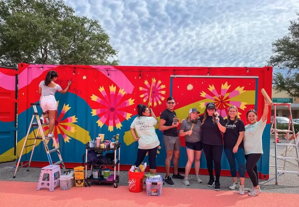 Modified shipping container being painted